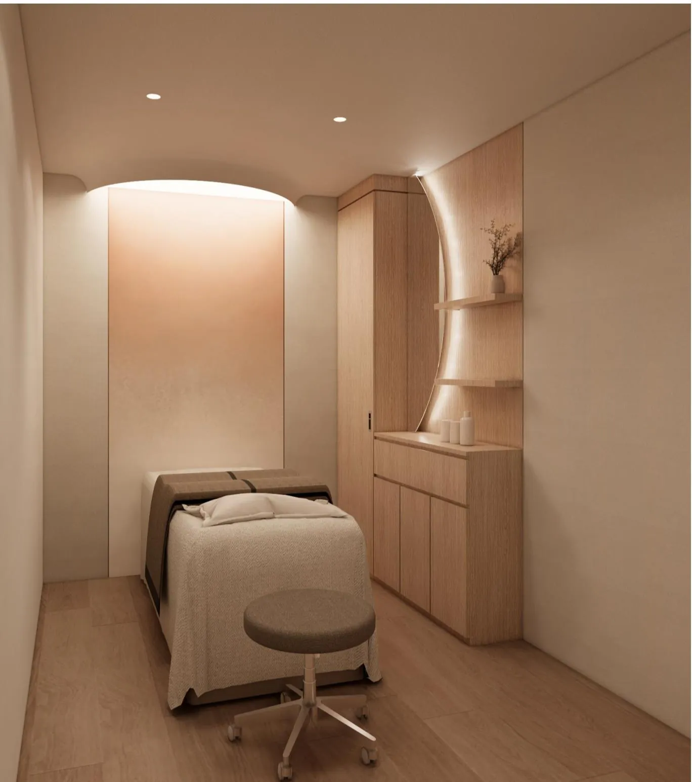 A single-occupancy VIP treatment room at Kind Global Clinic Myeongdong with a treatment bed, light oak cabinetry and warm indirect lighting.